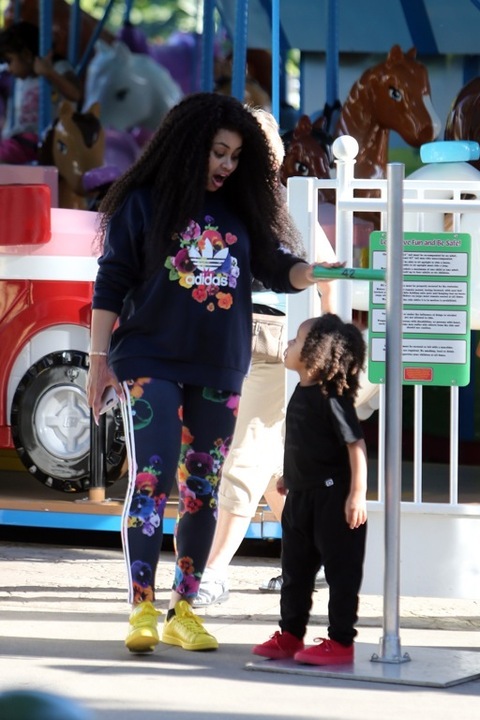 **PREMIUM RATES APPLY**  Rob Kardashian enjoys a day at Legoland with girlfriend Blac Chyna and rides a slide with her son King Cairo in Los Angeles. Rob was holding a water bottle as he walked with his girl and her son through the fun park. Rob was also spotted taking photos of her as the group went through their fun day together. They were also laughing together as they rode on the back of a rollercoaster with other members of her family a day before his birthday.